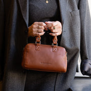 Styled Fit Perspective of Dalford Full-Grain Leather Handbag نسائي on Model - Natural Daylight Drape
