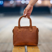 Styled Fit Perspective of Hermosa Full-Grain Leather Handbag نسائي on Model - Natural Daylight Drape